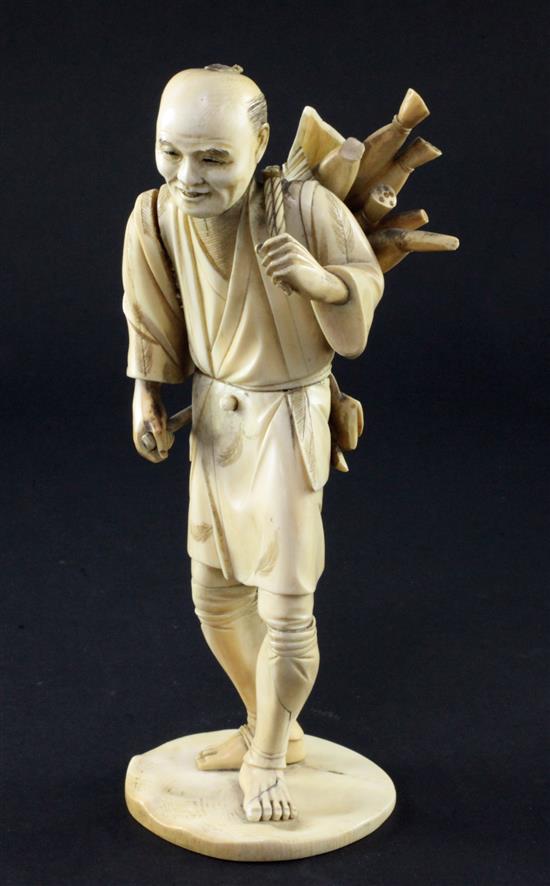 A Japanese sectional ivory figure of a farmer, 21.5cm